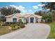 House exterior showcasing a tile roof, landscaping, and a paved driveway at 9090 Alexandria Dr, Weeki Wachee, FL 34613