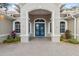 Front entrance with blue double doors and decorative columns at 9090 Alexandria Dr, Weeki Wachee, FL 34613