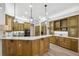 Gourmet kitchen with wood cabinets and expansive island at 9090 Alexandria Dr, Weeki Wachee, FL 34613