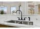 Modern kitchen sink with black faucet and white quartz countertop at 9090 Alexandria Dr, Weeki Wachee, FL 34613