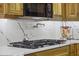 Gas cooktop with white quartz countertops and wood cabinets at 9090 Alexandria Dr, Weeki Wachee, FL 34613