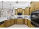 L-shaped kitchen with wood cabinets, gas cooktop and built-in oven at 9090 Alexandria Dr, Weeki Wachee, FL 34613
