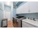 Functional laundry room with washer, dryer, and utility sink at 9090 Alexandria Dr, Weeki Wachee, FL 34613