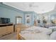 Main bedroom with light blue walls and king bed at 9090 Alexandria Dr, Weeki Wachee, FL 34613