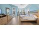 Spacious main bedroom with wood floors and pool view at 9090 Alexandria Dr, Weeki Wachee, FL 34613