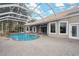 Large, screened pool with a rock waterfall feature at 9090 Alexandria Dr, Weeki Wachee, FL 34613