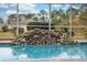 Relaxing pool area with a stone waterfall feature at 9090 Alexandria Dr, Weeki Wachee, FL 34613