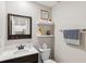 Small powder room with floating vanity and decorative shelving at 9173 Shadyside Ln, Land O Lakes, FL 34637