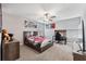 Well-lit bedroom with a desk and window coverings at 9173 Shadyside Ln, Land O Lakes, FL 34637