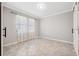 Simple bedroom with neutral walls and tile flooring, featuring two windows at 9173 Shadyside Ln, Land O Lakes, FL 34637