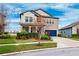 Two-story house with a blue garage door and manicured landscaping at 9173 Shadyside Ln, Land O Lakes, FL 34637