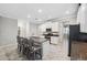 Modern kitchen with white cabinets, granite countertops, and island seating at 9173 Shadyside Ln, Land O Lakes, FL 34637