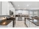 Modern kitchen with white cabinets, granite counters, and stainless steel appliances at 9173 Shadyside Ln, Land O Lakes, FL 34637