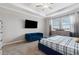 Main bedroom with a blue upholstered bed, and a sitting area at 9173 Shadyside Ln, Land O Lakes, FL 34637