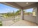 View from a balcony overlooking a residential street with palm trees at 9323 Bella Vita Cir, Land O Lakes, FL 34637