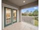 Covered balcony overlooking backyard and trees at 9323 Bella Vita Cir, Land O Lakes, FL 34637