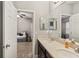 Elegant bathroom with double vanity, and access to bedroom at 9323 Bella Vita Cir, Land O Lakes, FL 34637