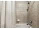 Bathroom with shower/tub combo and neutral tile at 9323 Bella Vita Cir, Land O Lakes, FL 34637