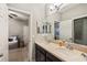 Clean bathroom with double vanity, and access to bedroom at 9323 Bella Vita Cir, Land O Lakes, FL 34637