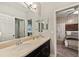 Modern bathroom with double vanity, and access to bedroom at 9323 Bella Vita Cir, Land O Lakes, FL 34637