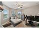 Bright bedroom with a comfortable bed, workspace, and ample natural light at 9323 Bella Vita Cir, Land O Lakes, FL 34637