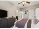 Relaxing bedroom with a comfy bed, TV, and access to a shared bathroom at 9323 Bella Vita Cir, Land O Lakes, FL 34637