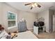 Cozy bedroom with a comfortable bed, workspace, and built-in shelving at 9323 Bella Vita Cir, Land O Lakes, FL 34637