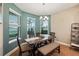 Bright dining room with a wooden table, bench seating, and a view to the backyard at 9323 Bella Vita Cir, Land O Lakes, FL 34637
