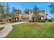 Two-story house with a balcony, two-car garage, and a well-maintained lawn at 9323 Bella Vita Cir, Land O Lakes, FL 34637
