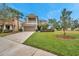 Two-story house with a balcony, two-car garage, and a nicely landscaped yard at 9323 Bella Vita Cir, Land O Lakes, FL 34637