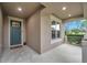 Modern front entrance with a teal door and sidelights at 9323 Bella Vita Cir, Land O Lakes, FL 34637