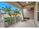 Inviting front porch with palm trees and view of the neighborhood at 9323 Bella Vita Cir, Land O Lakes, FL 34637