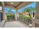 Covered front porch with white railing and view of neighborhood at 9323 Bella Vita Cir, Land O Lakes, FL 34637