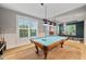 Fun game room featuring a pool table and hardwood floors at 9323 Bella Vita Cir, Land O Lakes, FL 34637