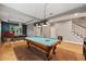 Spacious game room with pool table and view of dining area at 9323 Bella Vita Cir, Land O Lakes, FL 34637