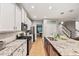 Modern kitchen with white cabinets, granite countertops, and a blue island at 9323 Bella Vita Cir, Land O Lakes, FL 34637