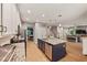 Modern kitchen with white cabinets, granite countertops, and a blue island at 9323 Bella Vita Cir, Land O Lakes, FL 34637