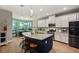 Modern kitchen featuring granite countertops, white cabinets, and a breakfast bar at 9323 Bella Vita Cir, Land O Lakes, FL 34637