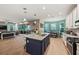 Open concept kitchen with an island, stainless steel appliances, and wood flooring at 9323 Bella Vita Cir, Land O Lakes, FL 34637