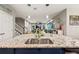 Open concept kitchen with an island, stainless steel appliances, and wood flooring at 9323 Bella Vita Cir, Land O Lakes, FL 34637