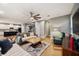 Open concept living area with hardwood floors, comfy sofas, and a view into the kitchen at 9323 Bella Vita Cir, Land O Lakes, FL 34637