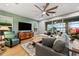 Bright living room with comfy seating, large TV, and access to a screened lanai at 9323 Bella Vita Cir, Land O Lakes, FL 34637
