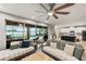 Living room with sliding doors leading to a pool and screened patio area at 9323 Bella Vita Cir, Land O Lakes, FL 34637