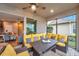 Covered patio with yellow couches and a view into the house at 9323 Bella Vita Cir, Land O Lakes, FL 34637