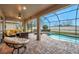 Screened patio with pool and lounge chairs at 9323 Bella Vita Cir, Land O Lakes, FL 34637