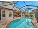 Inviting pool and spa with screened enclosure, perfect for relaxation at 9323 Bella Vita Cir, Land O Lakes, FL 34637