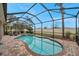 Relaxing screened pool and spa area with brick pavers at 9323 Bella Vita Cir, Land O Lakes, FL 34637
