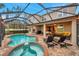 Inviting pool and spa with covered patio and lounge chairs at 9323 Bella Vita Cir, Land O Lakes, FL 34637