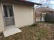 View of backyard with wooden fence and exterior door at 10185 Horizon Dr, Spring Hill, FL 34608