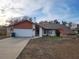 Ranch-style home with attached garage and mature landscaping at 10185 Horizon Dr, Spring Hill, FL 34608